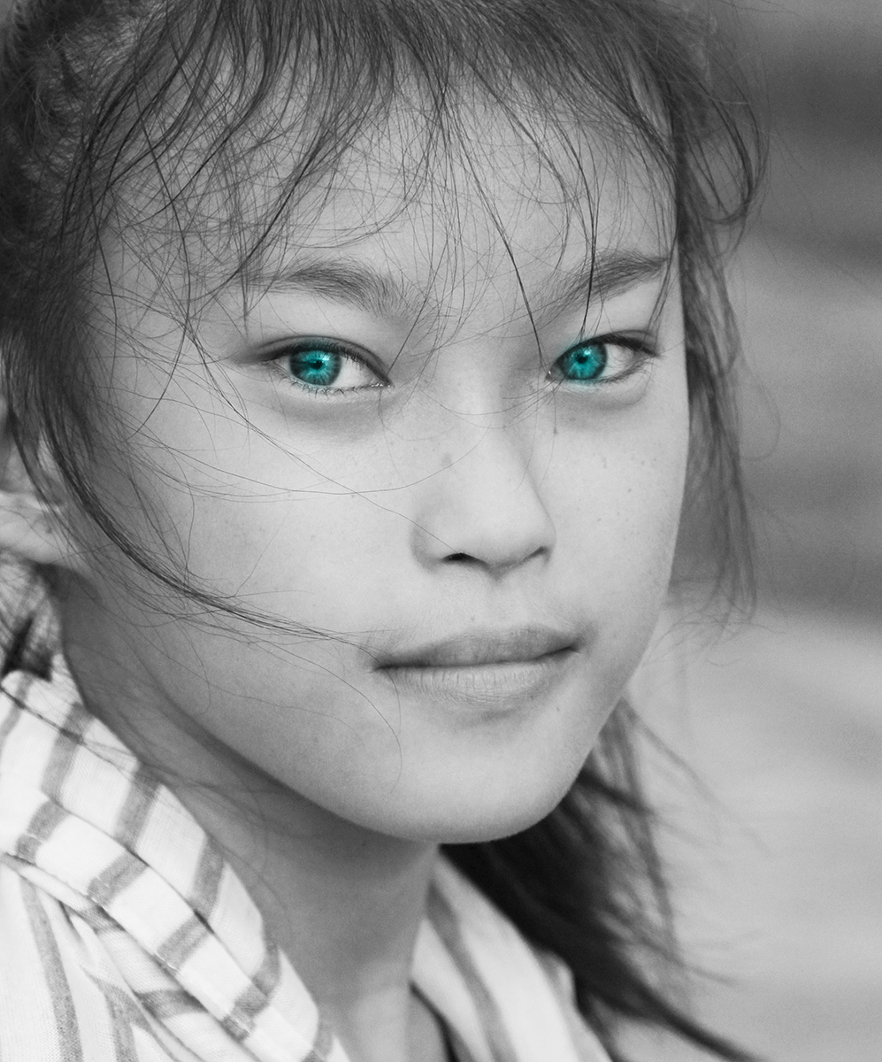 Portrait of a young Lao girl with striking green eyes